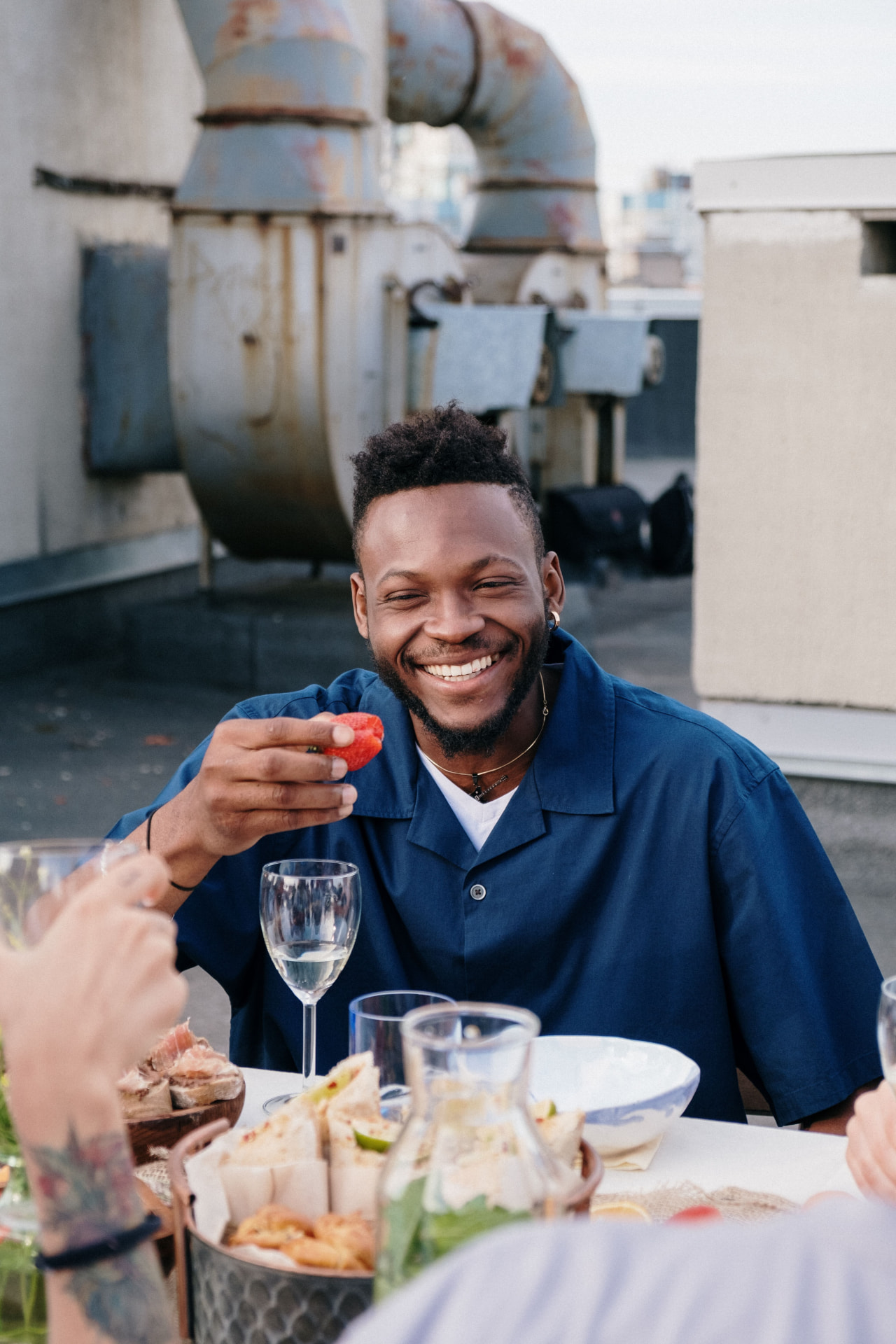 Host welcoming a new member over food and drinks